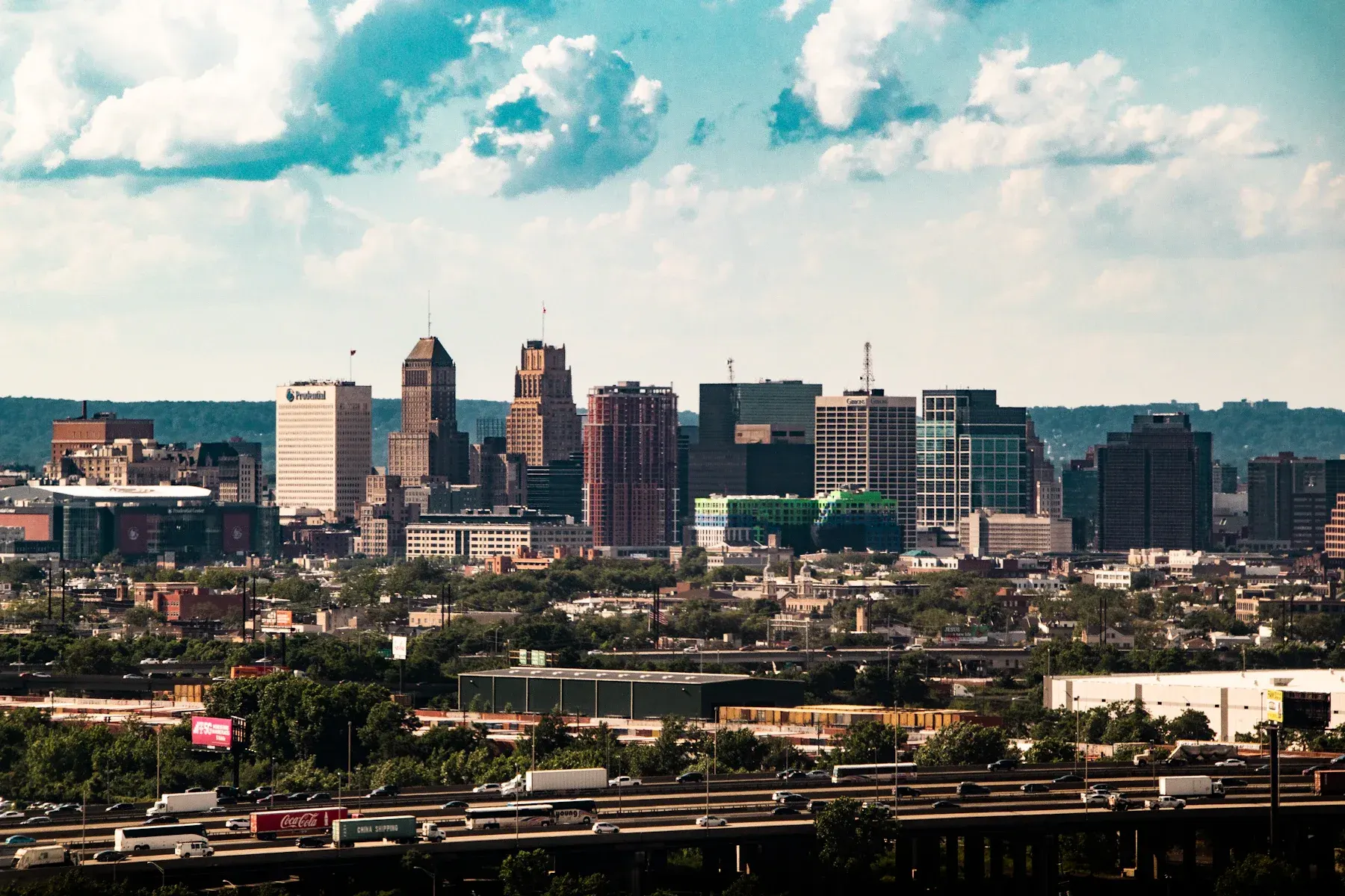 Detroit skyline with downtown buildings and industrial foreground under blue sky